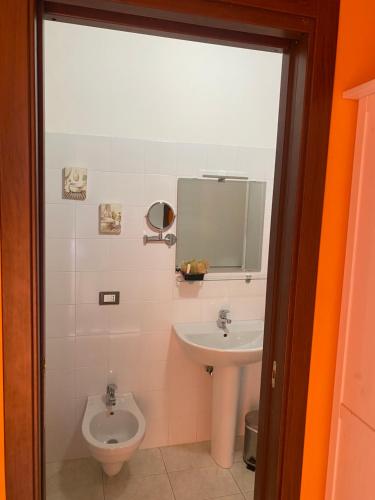 a bathroom with a toilet and a sink at Lo Scoiattolo Country House in Montorio al Vomano