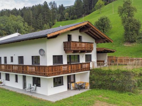 a large white house with wooden balconies at Apartment Mäuerl by Interhome in Hart im Zillertal