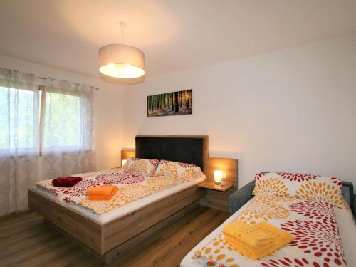 a bedroom with two twin beds and a window at Apartment Mäuerlhof by Interhome in Hart im Zillertal