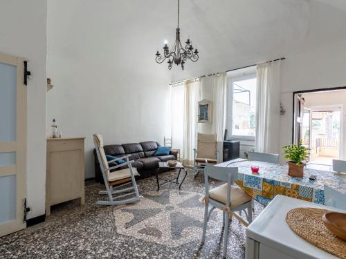 een woonkamer met een bank en een tafel bij Apartment Elisa by Interhome in Imperia
