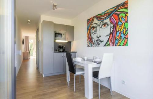 a kitchen and dining room with a table and a painting at B - HOME Apartments in Koblenz