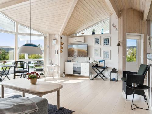 a living room with a table and chairs at Holiday Home Skaghi - 500m from the sea in Sealand by Interhome in Føllenslev