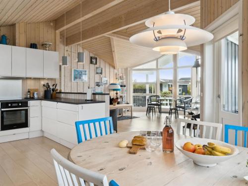 a kitchen and dining room with a table and chairs at Holiday Home Skaghi - 500m from the sea in Sealand by Interhome in Føllenslev