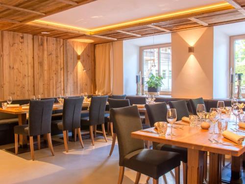 a dining room with wooden tables and chairs at Apartment Max by Interhome in Stams