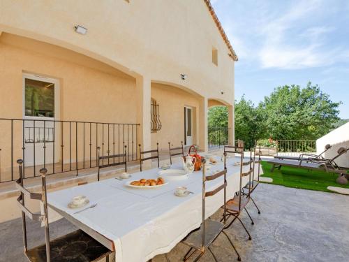 a table with a plate of food on a patio at Holiday Home Marges by Interhome in Bauduen