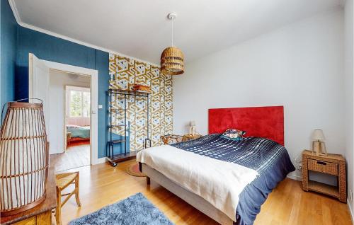 a bedroom with a bed and a colorful wall at 4 Bedroom Gorgeous Home In Jarnac in Jarnac