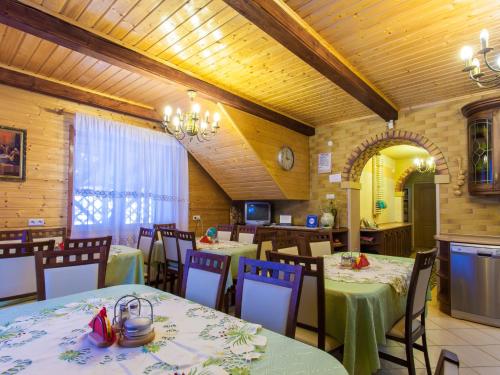 a restaurant with tables and chairs in a room at Holiday Home Antoś by Interhome in Baligród