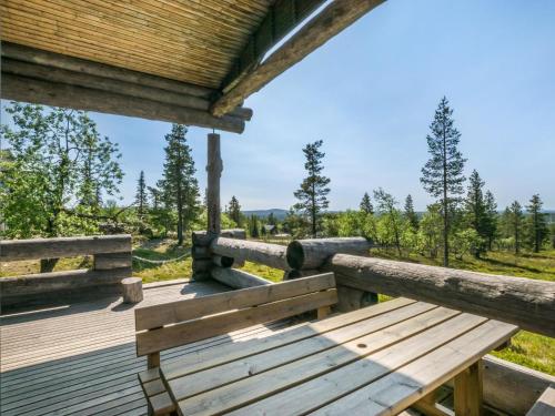 a wooden porch with a bench on a wooden deck at Holiday Home Kiehinen 1 by Interhome in Saariselka