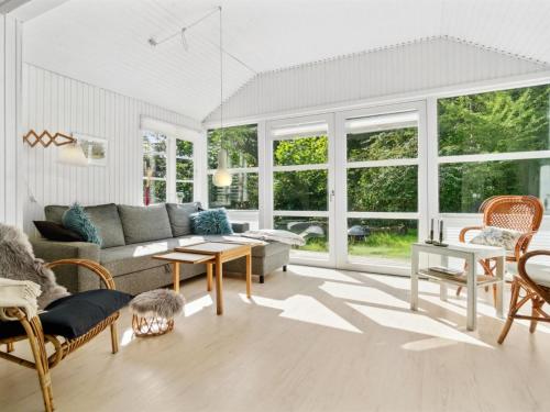 a living room with a couch and a table at Holiday Home Lucie - 50m from the sea in Bornholm by Interhome in Rønne