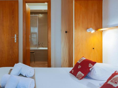 a bedroom with a bed and a bathroom at Apartment Jasmins 2 by Interhome in Veysonnaz