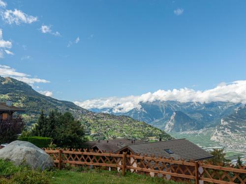 a view of the mountains from a wooden fence at Apartment Jasmins 2 by Interhome in Veysonnaz