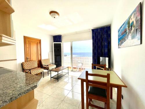 una cucina e un soggiorno con vista sull'oceano di Apartamento vista mar, a escasos metros de la playa a Tamaduste
