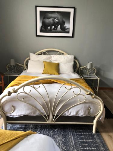 a bedroom with a large bed with pillows at De Sandsteen Gastehuis in Warden