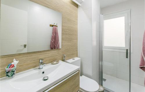 a bathroom with a sink and a toilet and a mirror at Beautiful Apartment In Granada With Kitchen in Granada