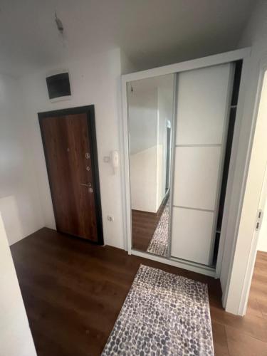 een lege kamer met een spiegel en een deur bij Downtown Great Apartment in Strumica