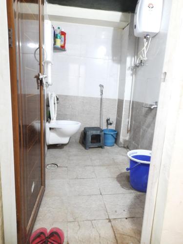 a small bathroom with a toilet and a sink at Shriguru Guest House Akkalkot in Akalkot