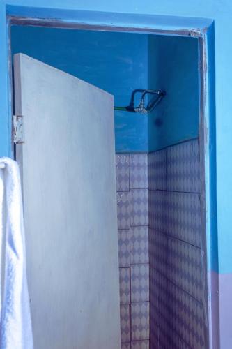 a shower with a glass door in a bathroom at Amadius in Lodwar