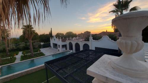 a villa with a swimming pool and a house at Maison d Hotes BLUE PALM Aix en PROVENCE in Aix-en-Provence