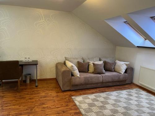 a living room with a couch and a table at Penzión a Reštaurácia Harmónia Ostratice in Malé Ostratice