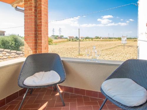 two chairs on a porch with a view of a field at Apartment Rina by Interhome in Cortona