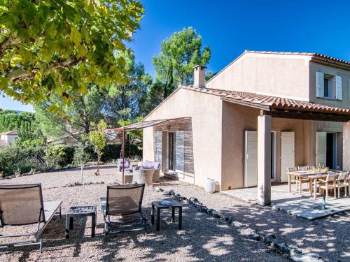 a villa with a patio and a table and chairs at Holiday Home Villa 10 by Interhome in Nans-les-Pins