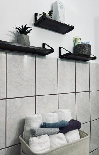 a bunch of towels are sitting on a shelf in a bathroom at STUDIO62 in Câmpulung Moldovenesc