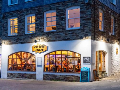 a restaurant with people sitting inside of a building at Apartment Lighthouse View by Interhome in Mevagissey