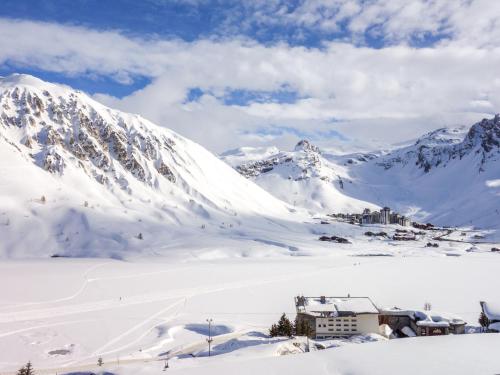 a snow covered mountain with a building in the foreground at Apartment Le Shamrock - Le Lac-6 by Interhome in Tignes