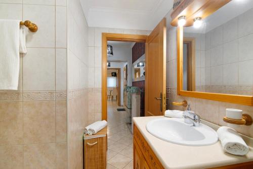 a bathroom with a sink and a shower at Apartamento do Sol in Albufeira