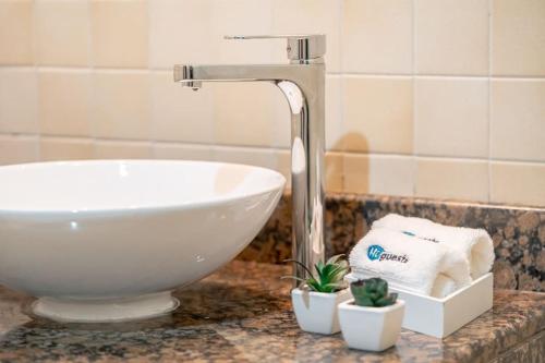 a sink and a faucet in a bathroom at HiGuests - Fancy 1BR Apt With Aerial Marina Views in JBR in Dubai