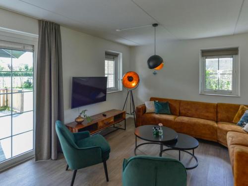 a living room with a couch and a tv at Holiday Home Citta Romana by Interhome in Hellevoetsluis