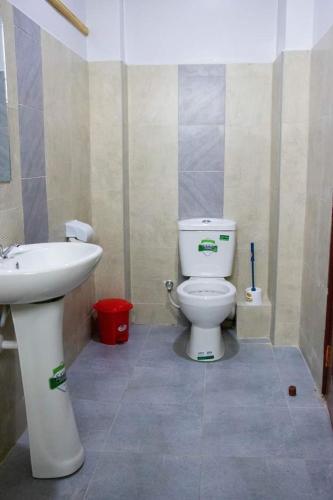 a bathroom with a toilet and a sink at GOLDEN PALM 3 in Nakuru