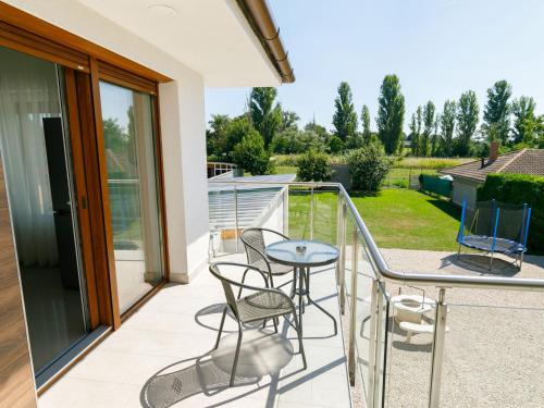 a balcony with a table and chairs on it at Apartment Johann 1 by Interhome in Balatonszárszó