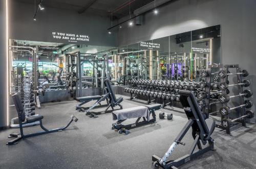 a gym with several rows of equipment in a room at Barceló Fortina Malta in Sliema