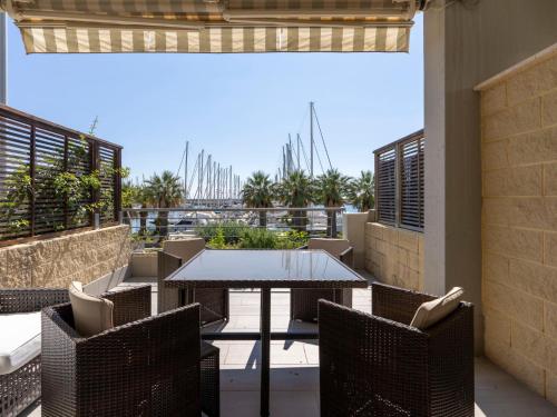 a patio with a table and chairs on a balcony at Apartment Blue Moon by Interhome in Santo Stefano al Mare