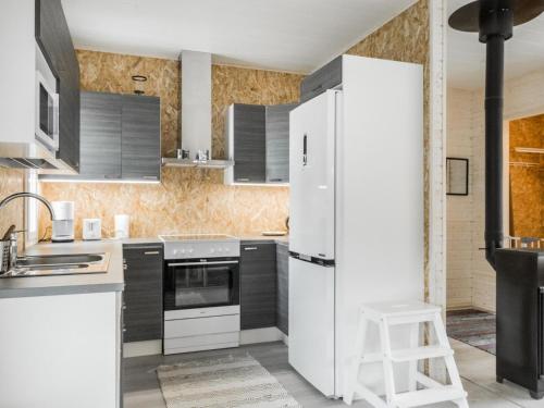 a kitchen with white appliances and a white refrigerator at Holiday Home Kaisala by Interhome in Hailuoto