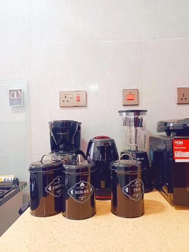 a kitchen counter with four blenders on a counter top at Mkabee Homes in Nairobi