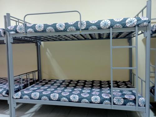 a bedroom with two bunk beds in a room at The Sky Hosteller Dubai in Dubai