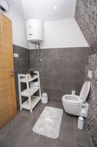 a bathroom with a toilet and a sink at Klek 77 Luxury Chalets near Jahorina in Paočići