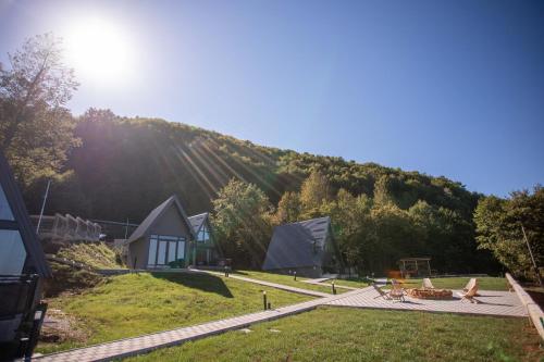 a view of a house with a mountain in the background at Klek 77 Luxury Chalets near Jahorina in Paočići