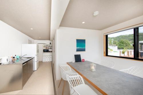 a kitchen and dining room with a table and chairs at Setouchi Island Stays Suo Oshima in Suo Oshima