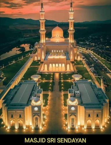 a large building with a mosque at night at 4 Bedrooms Homestay, Fully Aircond in Sendayan by D'KAY HOMES I 10-15 pax in Seremban