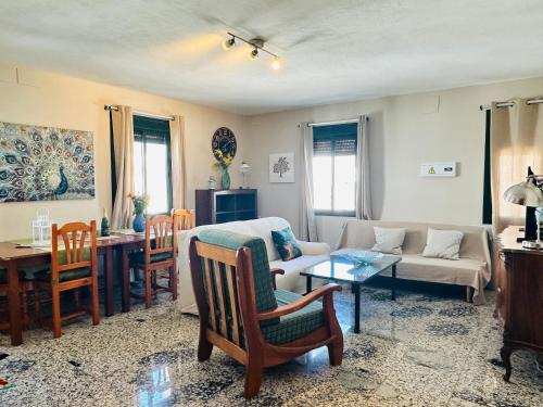 a living room with a couch and a table at Apartamentos Turísticos Santa Marina in Aracena