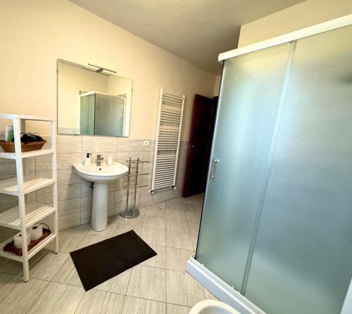 a bathroom with a sink and a glass shower at Casa Clelia in Ponte Buggianese