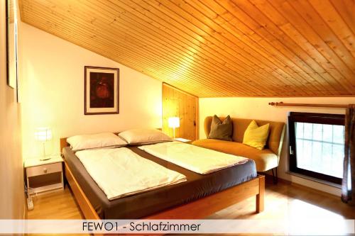a bedroom with a bed and a couch in it at Anica Iles in Viskovo