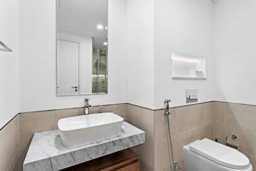 a bathroom with a sink and a toilet at StoneTree - Elegant 1 BR in Madinat Jumeirah Living Rahaal 2 in Dubai