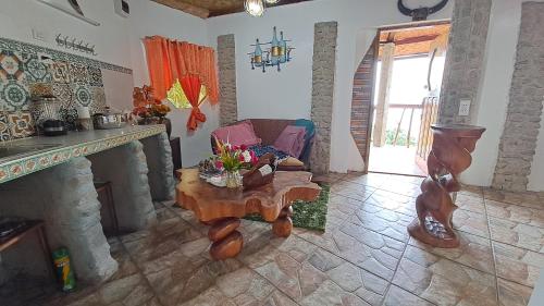 a living room with a fireplace and a table at Camiguin Romantic Luxury Stonehouse on Eco-Farm at 700masl in Mambajao