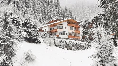 a house on the side of a snow covered mountain at Heimat Apartments - Zillertal in Gerlos