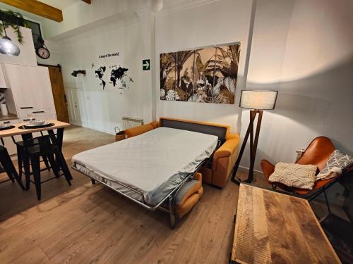 a room with a bed and a table and chairs at Apartamentos Santander 1 in Santander