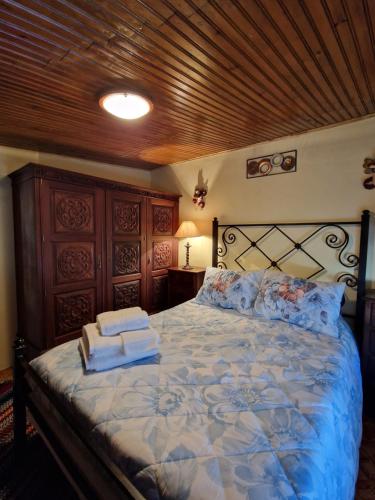 a bedroom with a large bed with towels on it at AL - Casa dos Alentejanos 